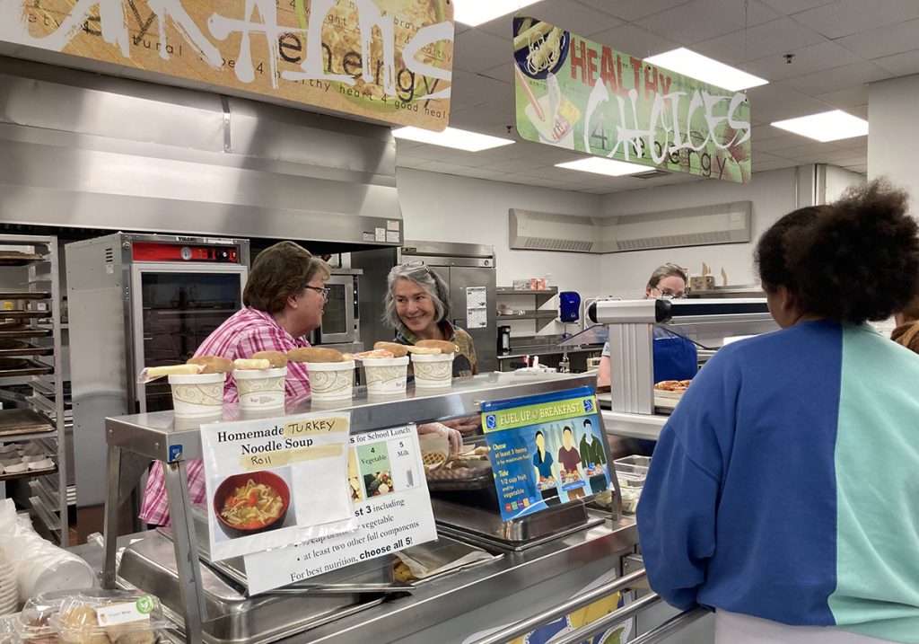 Sen. Eloise Vitelli (center) and Lisa Campbell serve lunch to Bath Middle School students.