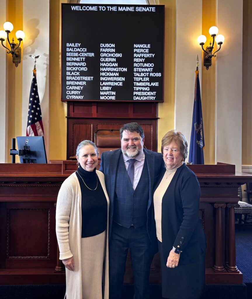 A photo of Sen. Chip Curry in the Senate Chamber, along with his wife, Christi Goosman, and mother, Barbara Curry, after being sworn in for his third term in the Maine State Senate.